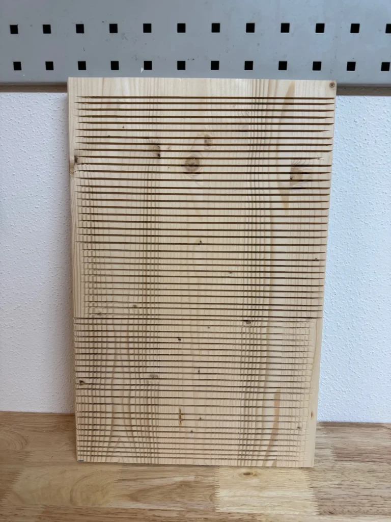 Holzbrett mit vielen gefrästen Nuten.