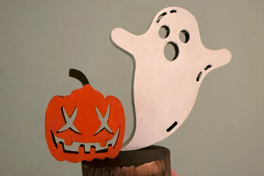 Zusammengesetzter Teelichthalter mit Halloween-Motiven Geist und Kürbis.