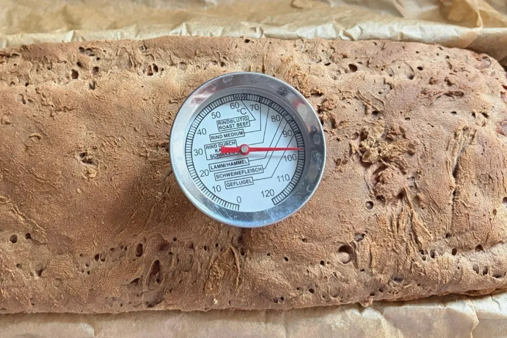 Kerntemperatur von Sauerteigbrot mit Thermometer gemessen bei etwa 98 Grad