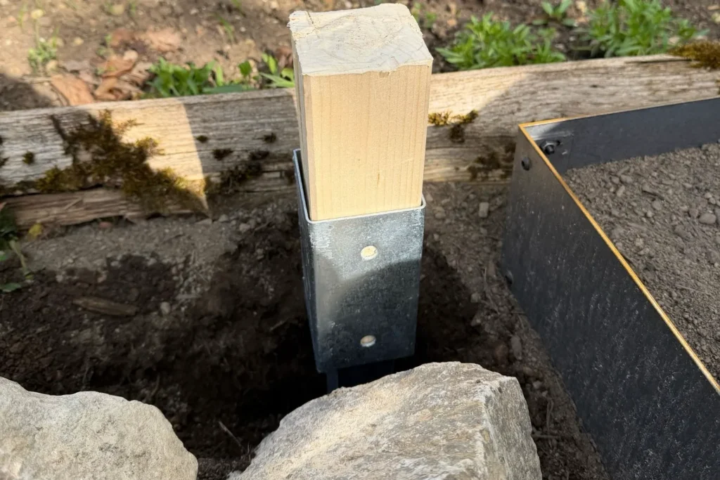 Eingeschlagene Bodenhülse in Endposition für Rankhilfe im Gartenboden